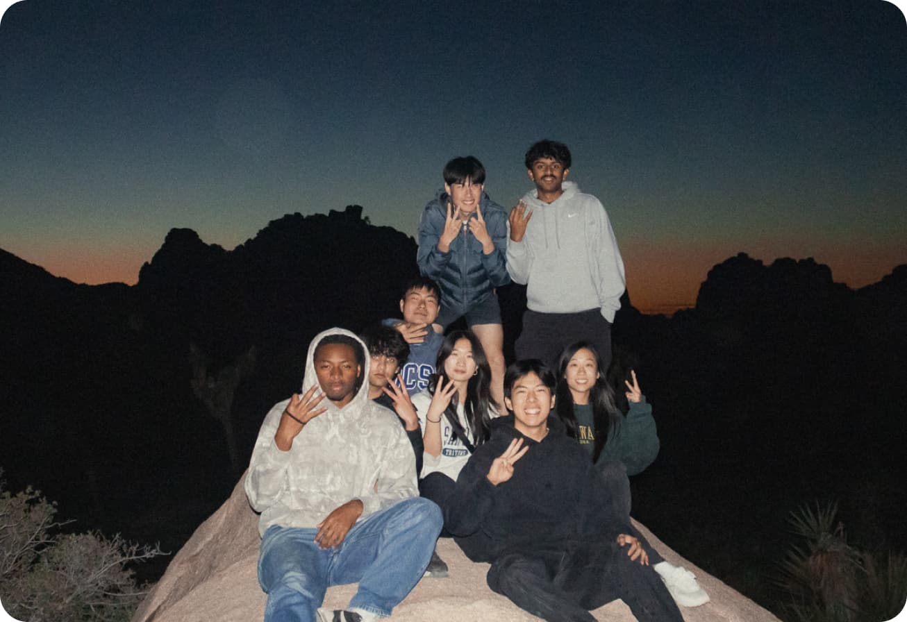 Alice and her TSE project team posing on a rock in Joshua Tree at dusk.