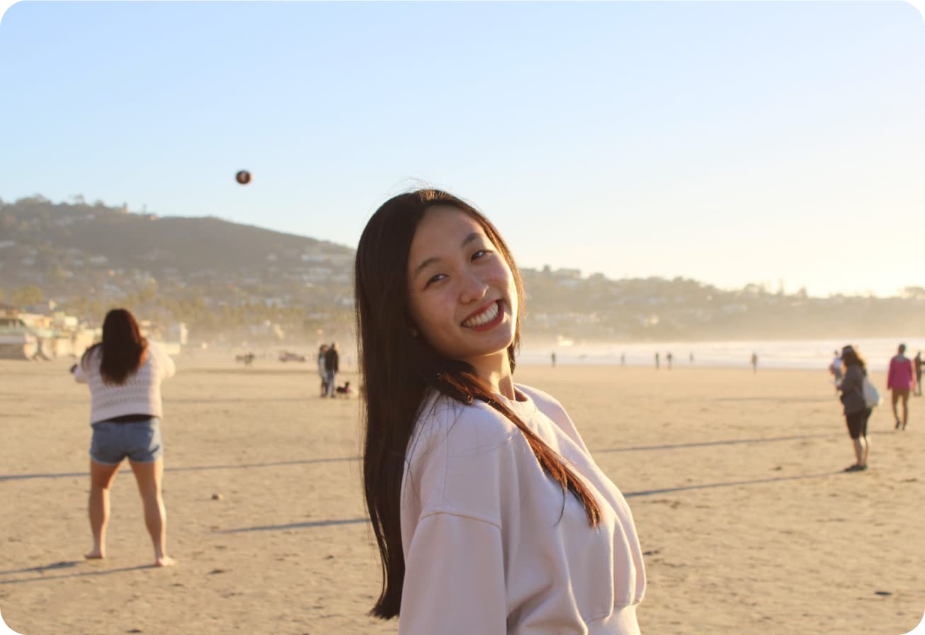 Alice smiling on a beach near campus in San Diego.